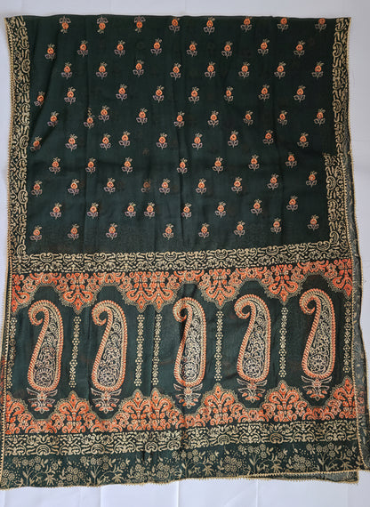 Black fabric with intricate gold and orange patterns on a white background